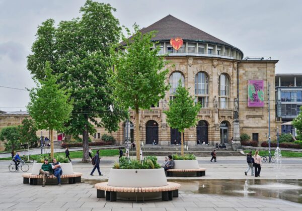 Drei Kübel mit Bäumen stehen als zusätzliche Schattenspender seit Dienstag auf dem Platz der Alten Synagoge – mit Rundbänken als Sitzgelegenheit.